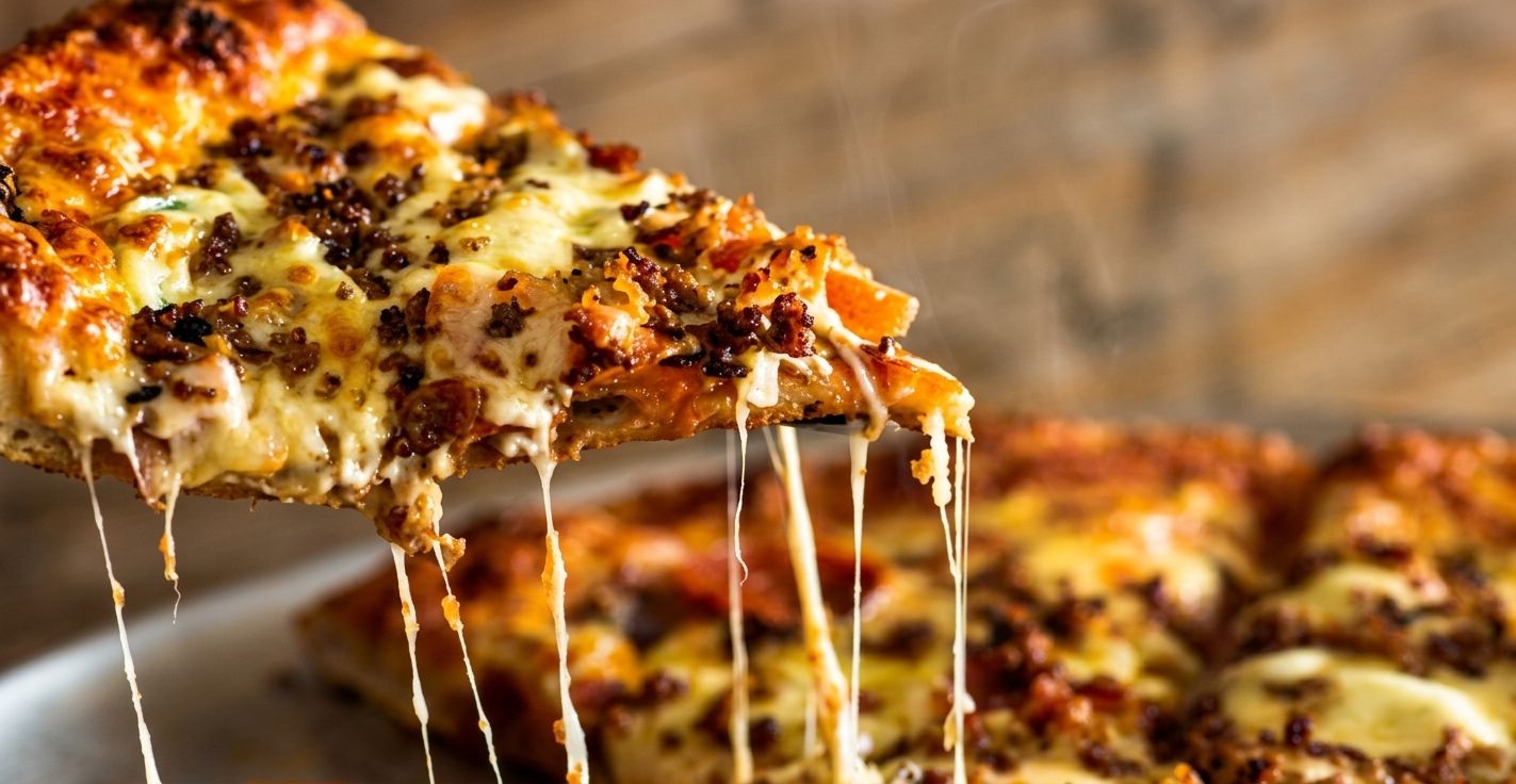 Slice of Lorenzo's pizza with a cheese pull